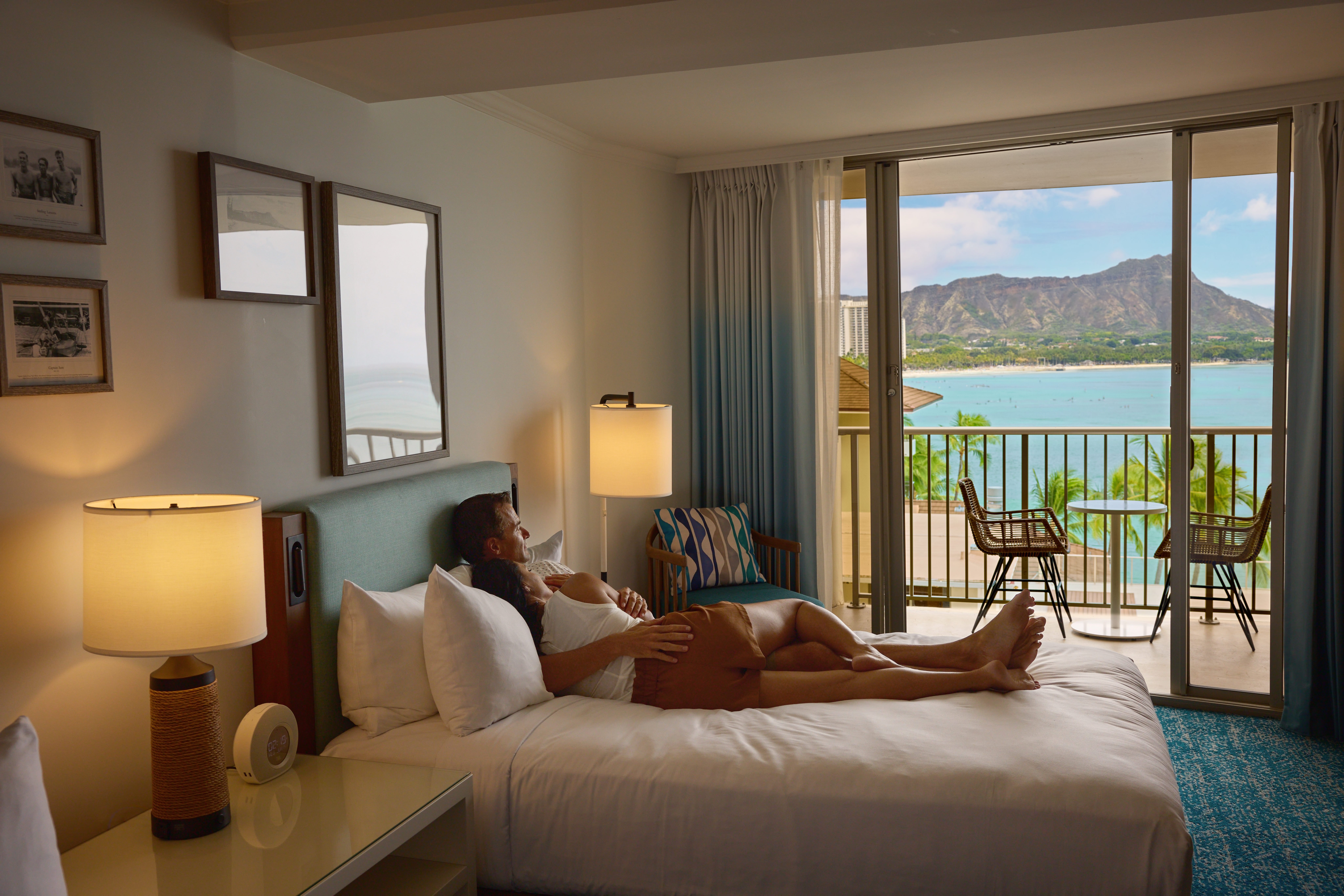 Couple lying in bed enjoying the view of Diamond Head